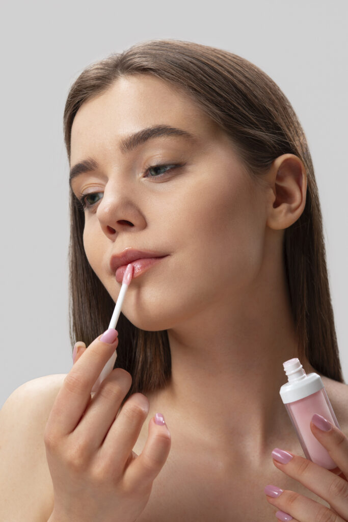 front-view-woman-using-lip-gloss